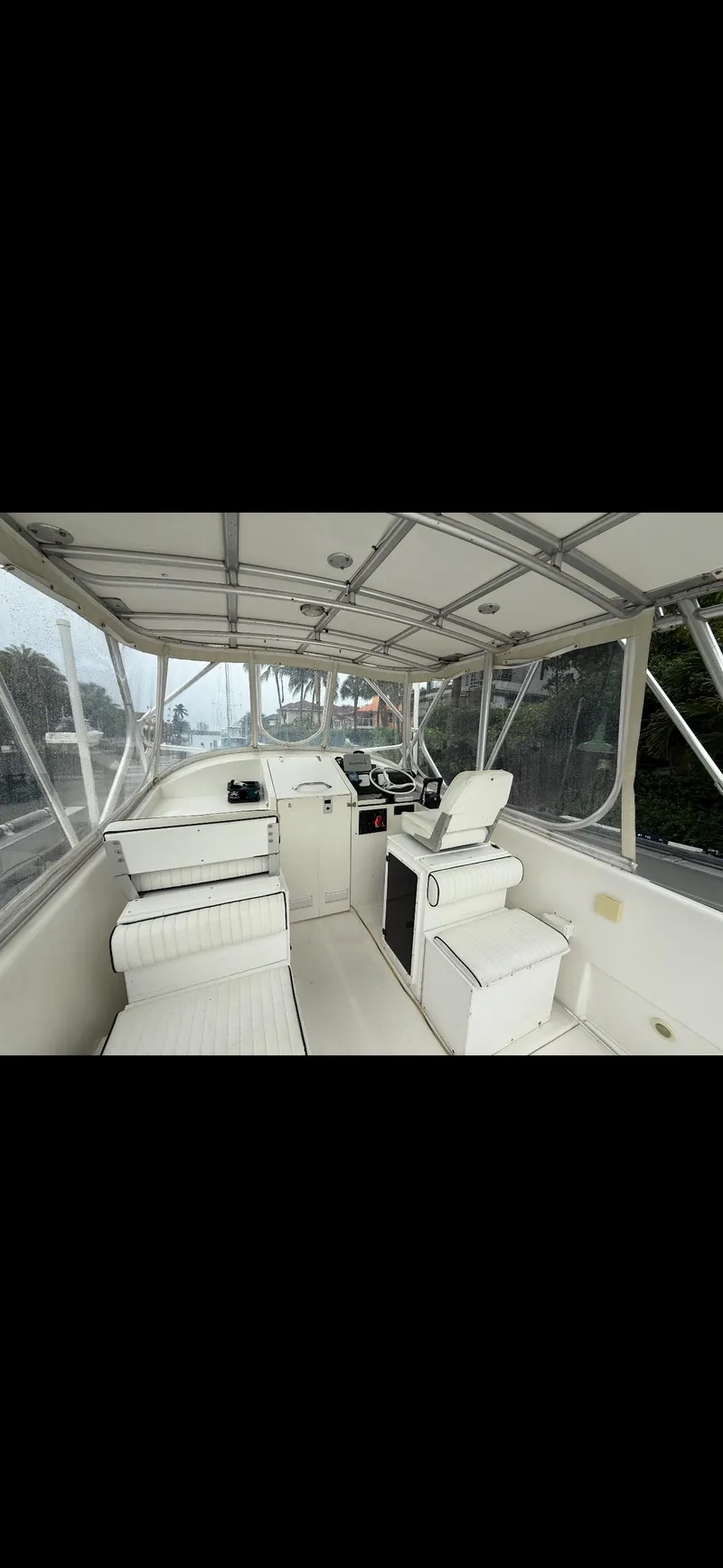 Slide: The Image of 2000 Powercat Catamaran interior with seating and helm, featuring a covered deck. - 5
