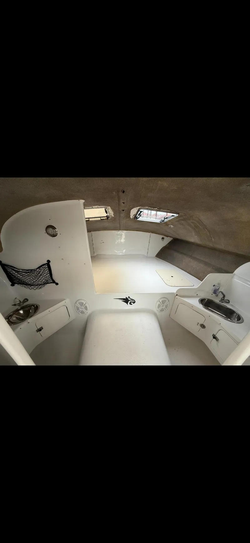 Slide: The Image of Interior of 2000 Powercat Catamaran, featuring compact cabin space with storage and seating. - 6