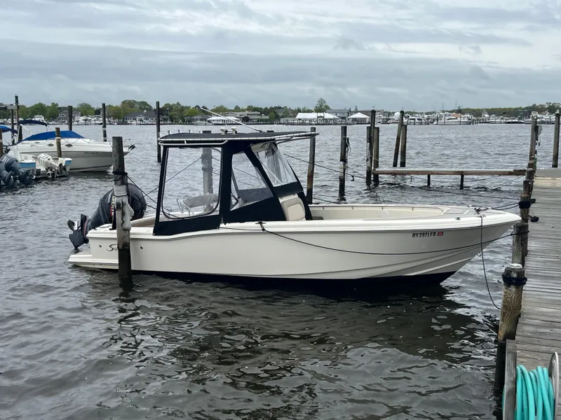 Slide: The Image of 2005 Scout 235 Sportfish boat docked on a cloudy day. - 6
