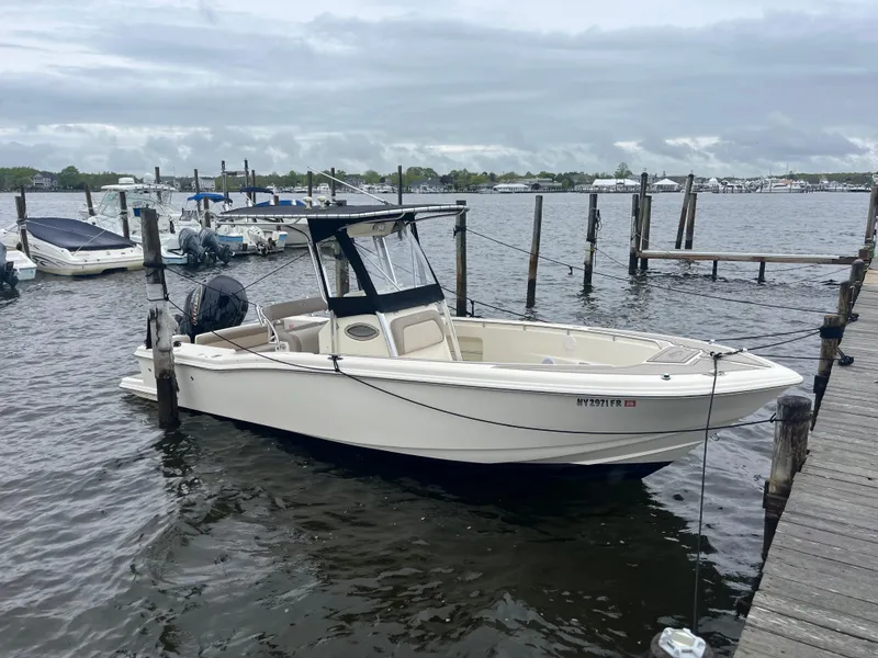 Slide: The Image of 2005 Scout 235 Sportfish boat docked at marina on cloudy day. - 7