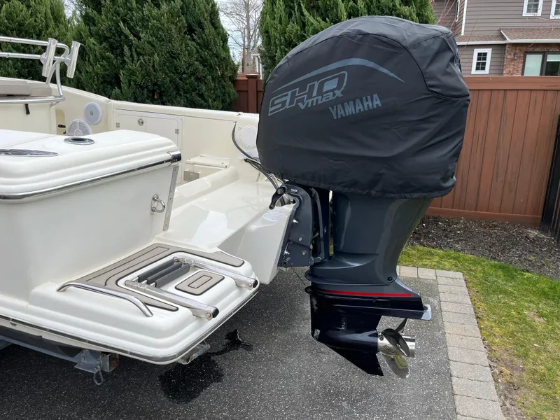 Slide: The Image of 2005 Scout 235 Sportfish boat with Yamaha outboard motor, parked on driveway. - 8