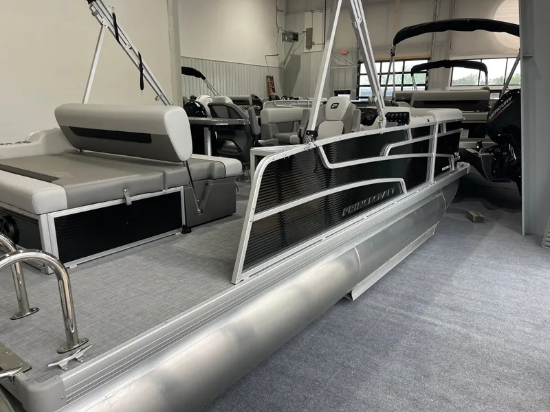 The Image of 2025 Princecraft Vectra 21 RL pontoon boat in showroom, featuring sleek design and spacious seating. - 1