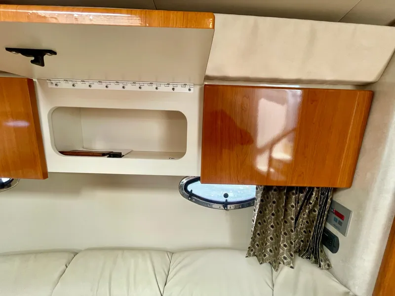 Slide: The Image of 2003 Formula 40 PC interior with wooden cabinets and porthole window. - 15