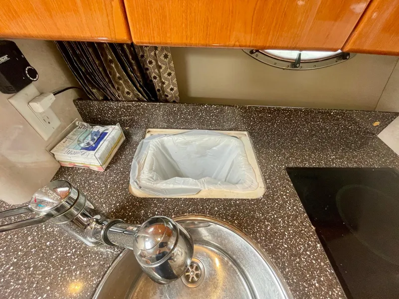 Slide: The Image of 2003 Formula 40 PC yacht kitchen with sink, countertop, and trash bin. - 21