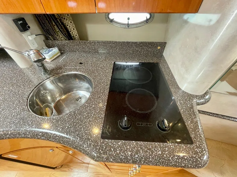 Slide: The Image of 2003 Formula 40 PC yacht kitchen with sleek countertop, sink, and electric stove. - 23