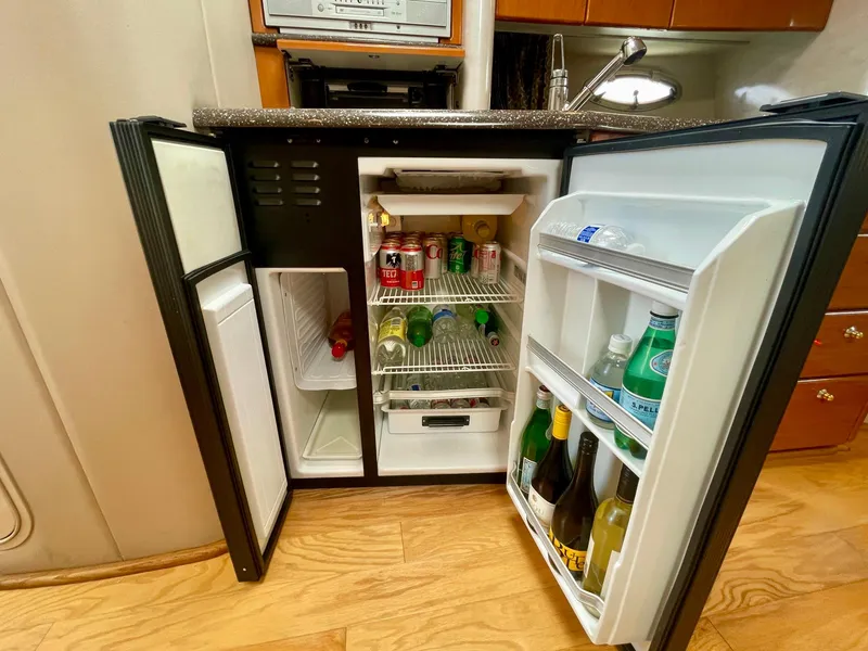 Slide: The Image of Mini fridge in 2003 Formula 40 PC yacht, stocked with beverages and snacks. - 24
