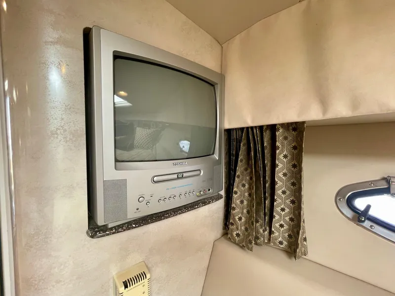 Slide: The Image of 2003 Formula 40 PC interior with vintage TV and patterned curtains. - 29