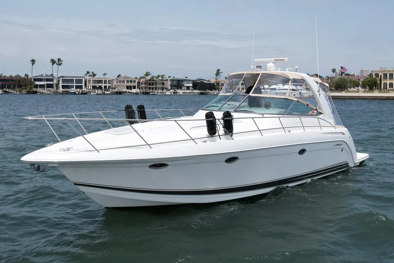 Slide: The Image of 2003 Formula 40 PC yacht cruising on a sunny day near waterfront homes. - 3