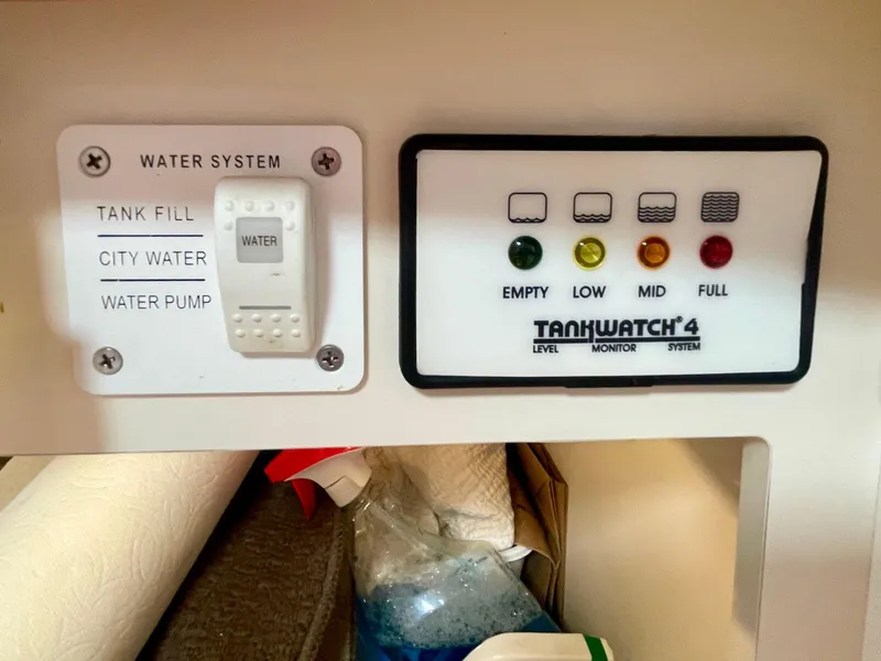 Slide: The Image of Control panel for water system and tank level monitor in a 2003 Formula 40 PC. - 38