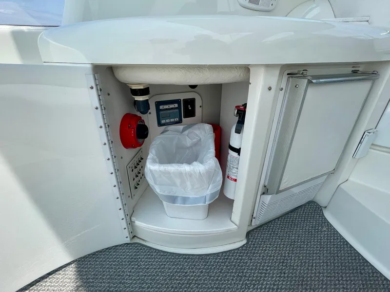 Slide: The Image of 2003 Formula 40 PC yacht interior with storage compartment, fire extinguisher, and trash bin. - 48