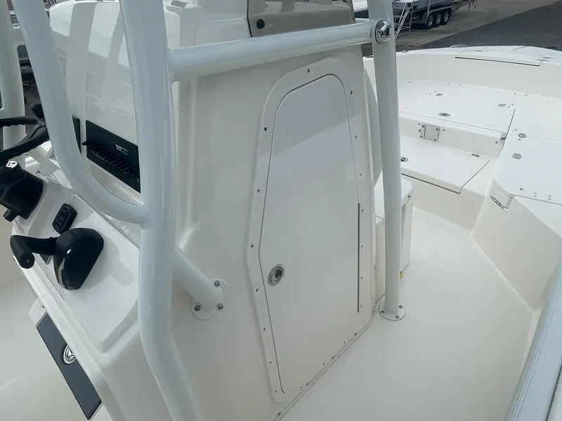 Slide: The Image of 2025 Pathfinder 2400 TRS boat console with steering wheel and storage compartment. - 10