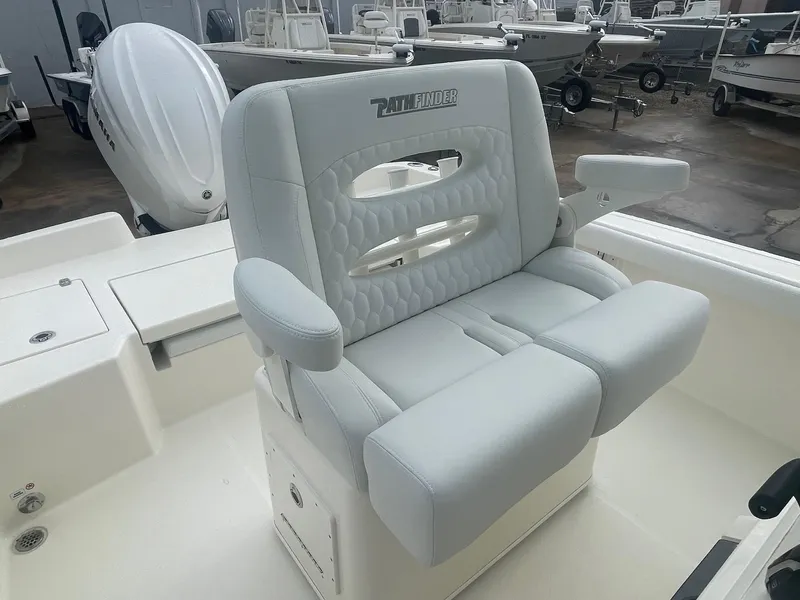 Slide: The Image of 2025 Pathfinder 2400 TRS boat seat, white upholstery, armrests, and storage compartment. - 13