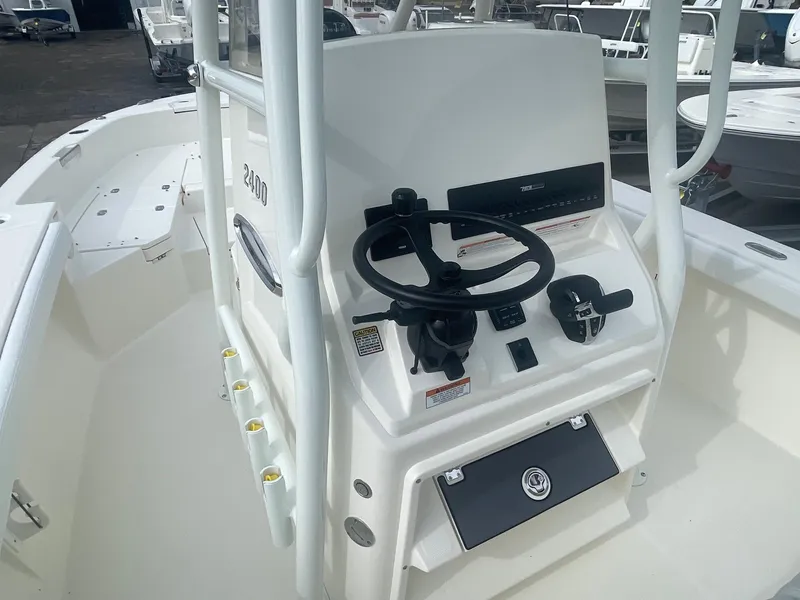 Slide: The Image of 2025 Pathfinder 2400 TRS boat console with steering wheel and controls. - 14