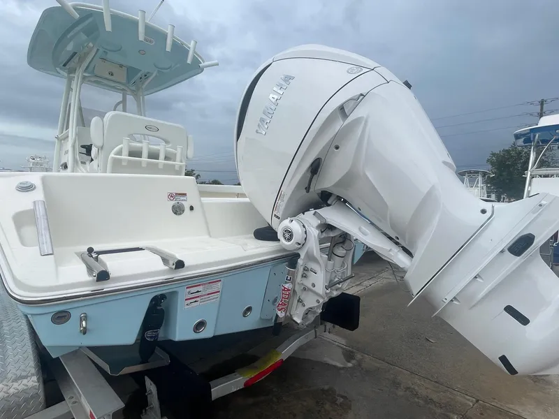 Slide: The Image of 2025 Pathfinder 2400 TRS boat with powerful outboard motor, parked on a trailer. - 3