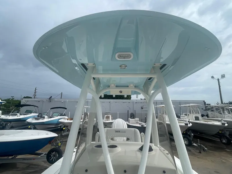 Slide: The Image of 2025 Pathfinder 2400 TRS boat with T-top, displayed in a marina setting. - 4