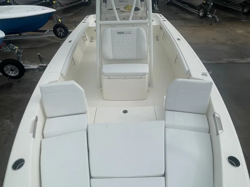 Slide: The Image of 2025 Pathfinder 2400 TRS boat interior with white seating and spacious deck layout. - 8