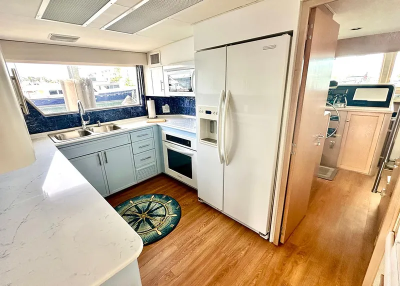 Slide: The Image of 1994 Hatteras Cockpit Motoryacht kitchen with modern appliances and wood flooring. - 11