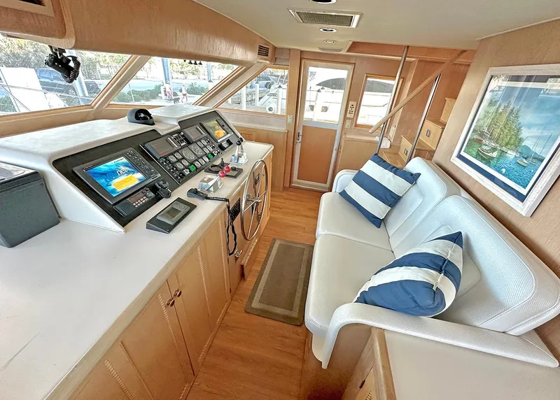 Slide: The Image of Interior of 1994 Hatteras Cockpit Motoryacht with helm, seating, and nautical decor. - 13