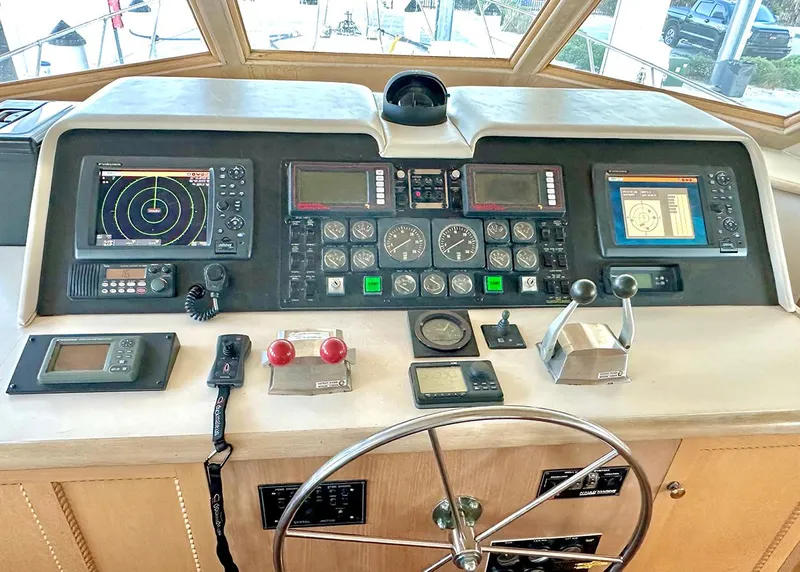 Slide: The Image of Control panel of a 1994 Hatteras Cockpit Motoryacht with navigation and communication equipment. - 14
