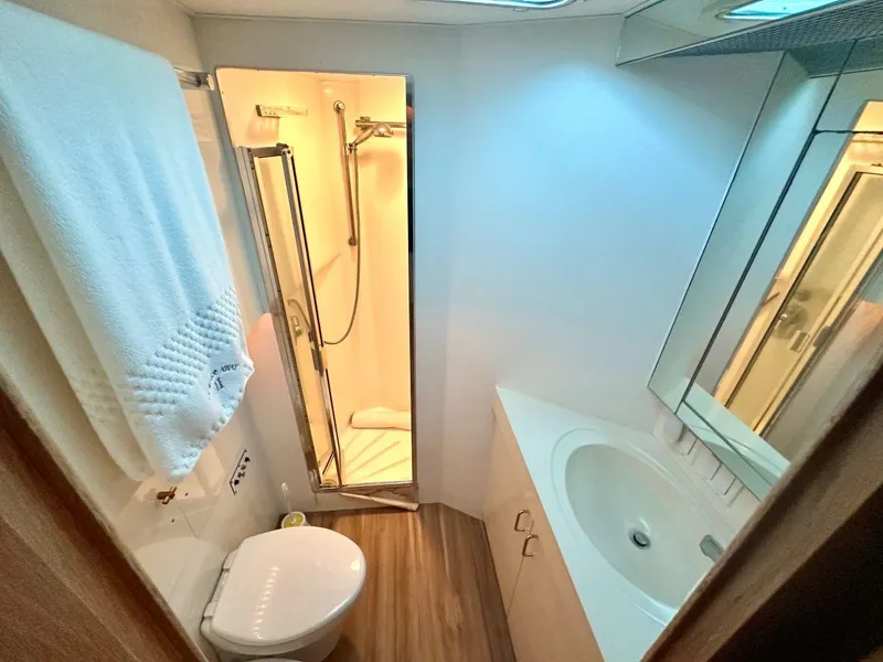 Slide: The Image of Bathroom interior of 1994 Hatteras Cockpit Motoryacht with shower, sink, and toilet. - 16