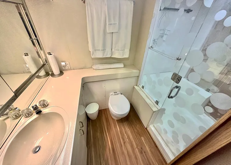 Slide: The Image of Bathroom interior of 1994 Hatteras Cockpit Motoryacht with shower, sink, and toilet. - 18