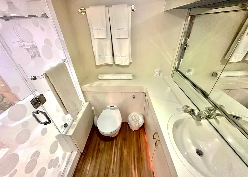 Slide: The Image of Bathroom interior of 1994 Hatteras Cockpit Motoryacht with modern fixtures and wooden flooring. - 19