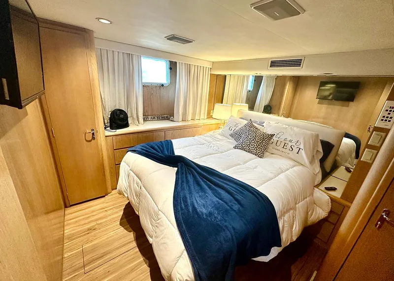 Slide: The Image of Luxurious bedroom in 1994 Hatteras Cockpit Motoryacht with cozy bedding and modern decor. - 20