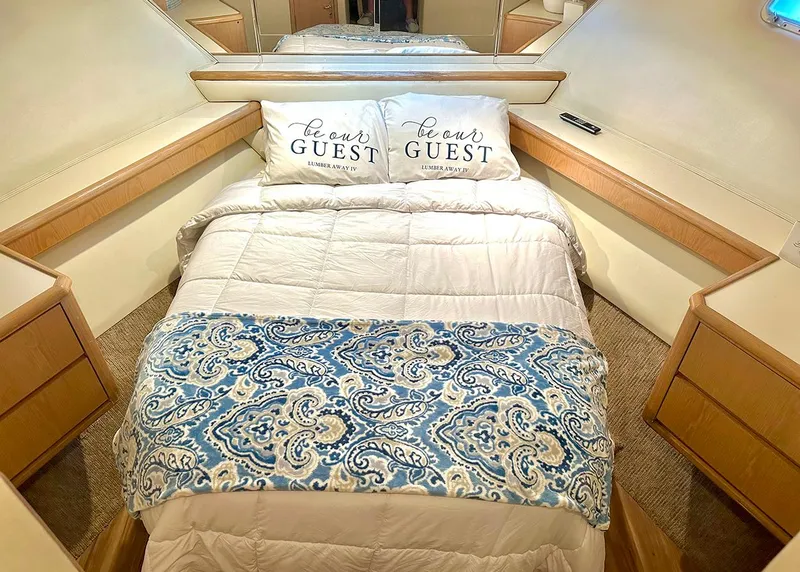 Slide: The Image of Luxurious bedroom in 1994 Hatteras Cockpit Motoryacht with elegant bedding and mirrored accents. - 22