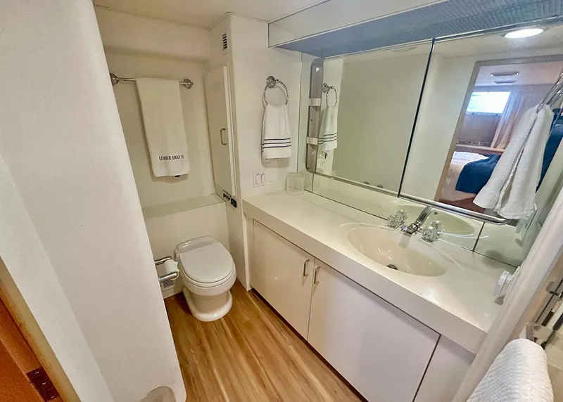 Slide: The Image of Bathroom interior of 1994 Hatteras Cockpit Motoryacht with modern fixtures and wood flooring. - 23