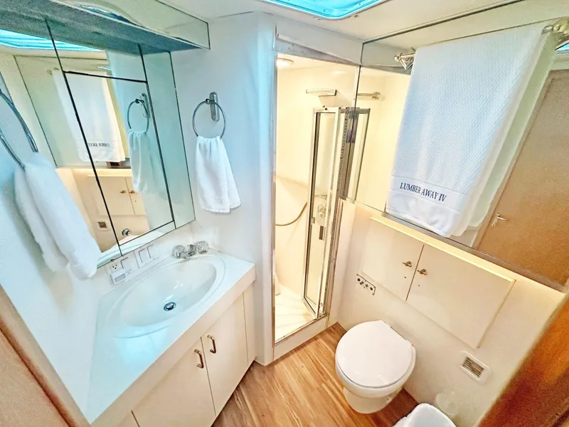 Slide: The Image of Luxurious bathroom in 1994 Hatteras Cockpit Motoryacht with shower, sink, and toilet. - 27