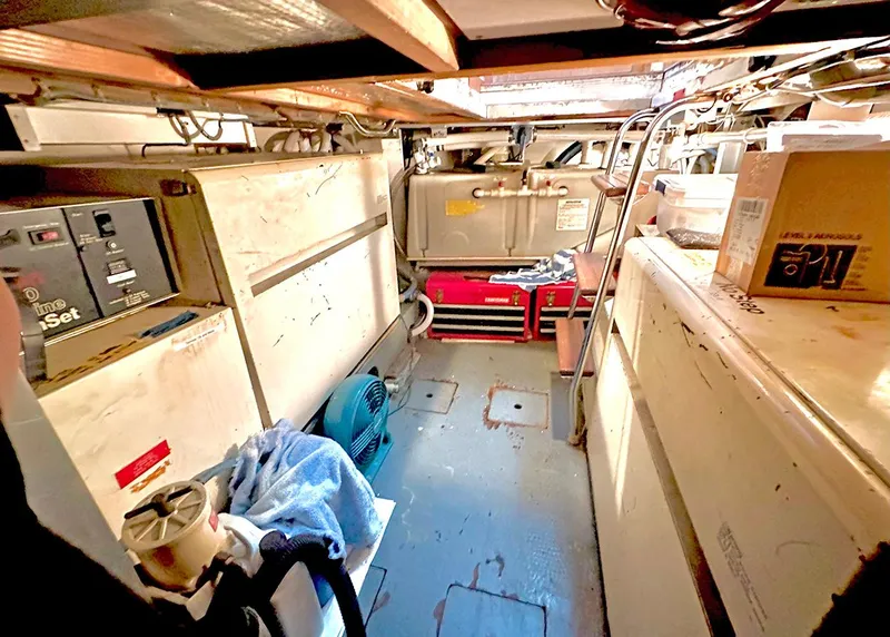 Slide: The Image of Engine room of a 1994 Hatteras Cockpit Motoryacht with equipment and storage boxes. - 33