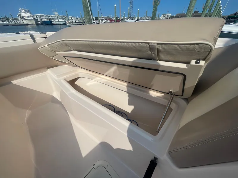 Slide: The Image of 2014 Grady-White Freedom 255 boat storage compartment open at marina. - 12
