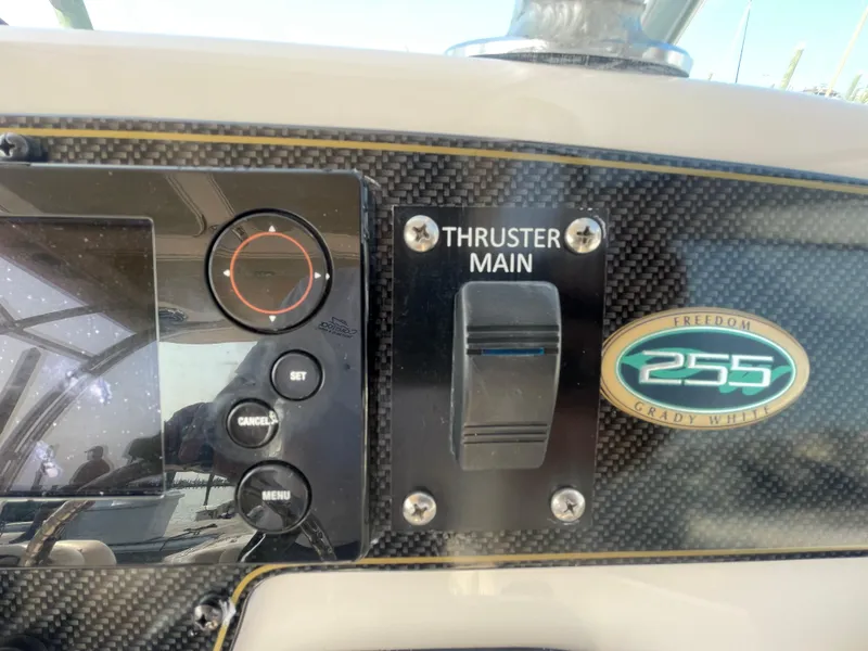 Slide: The Image of Control panel of 2014 Grady-White Freedom 255 boat with thruster switch. - 26
