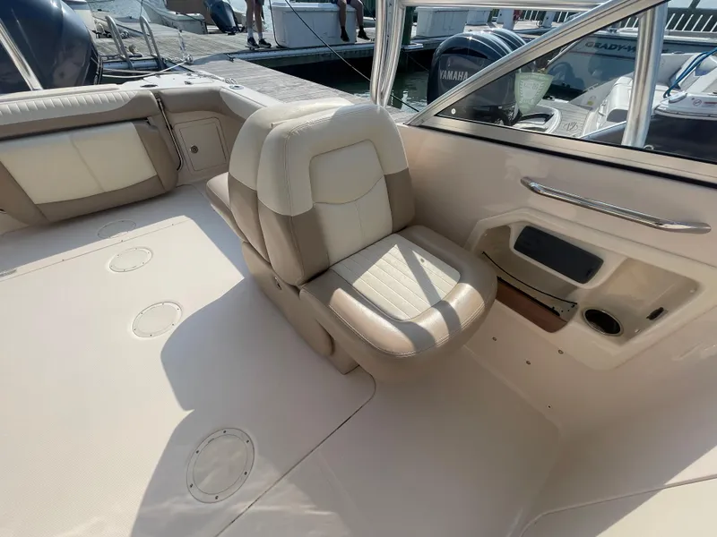 Slide: The Image of 2014 Grady-White Freedom 255 boat interior with beige seating and deck details. - 30