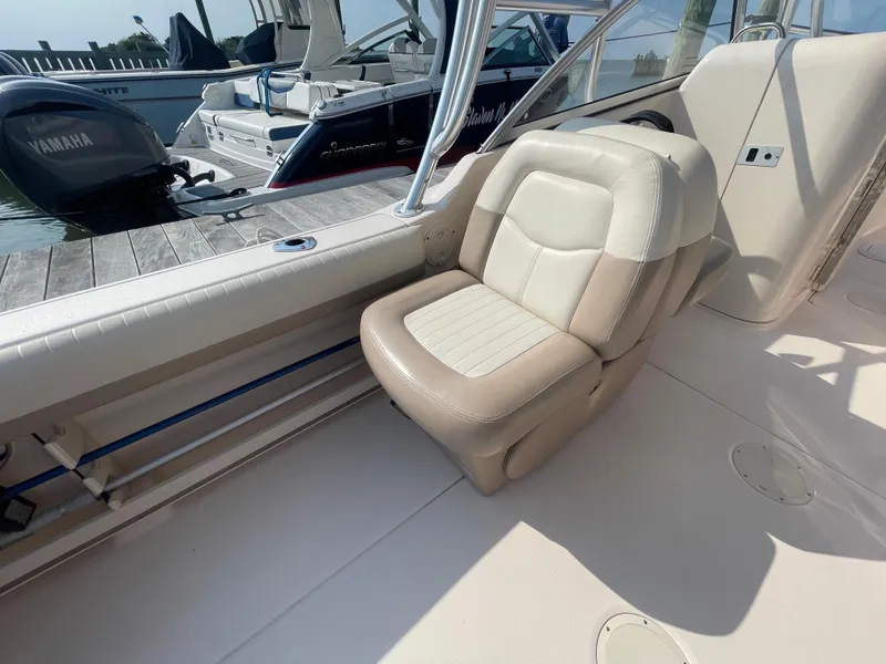 Slide: The Image of 2014 Grady-White Freedom 255 boat interior with beige seating and Yamaha engine. - 34
