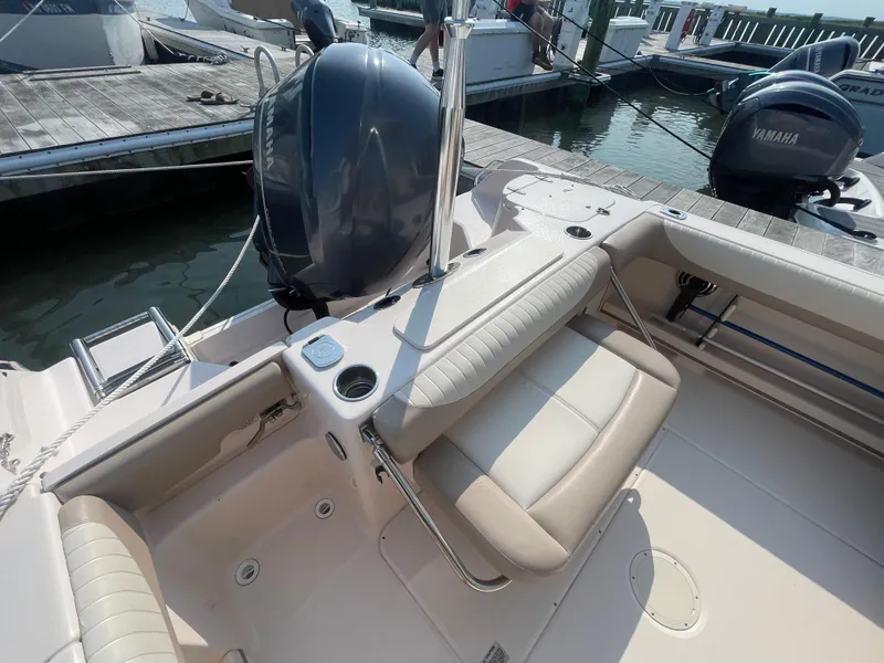 Slide: The Image of 2014 Grady-White Freedom 255 boat interior with seating and motor at dock. - 36