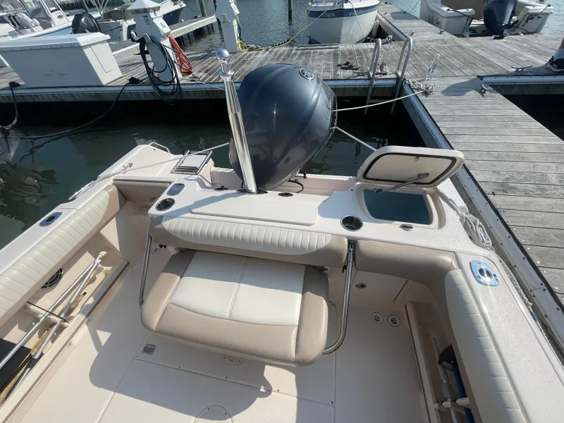 Slide: The Image of 2014 Grady-White Freedom 255 boat interior with seating and motor at dock. - 37