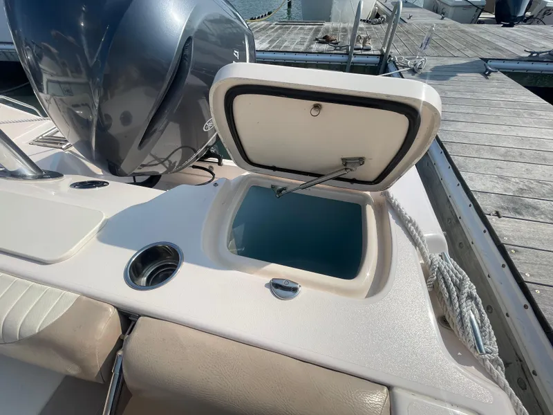 Slide: The Image of 2014 Grady-White Freedom 255 boat with open storage compartment on deck. - 38