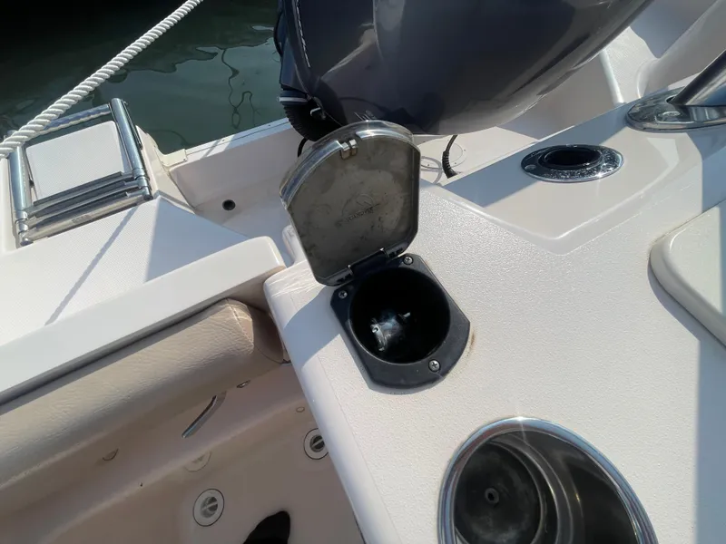 Slide: The Image of 2014 Grady-White Freedom 255 boat deck with open compartment and cup holder. - 39