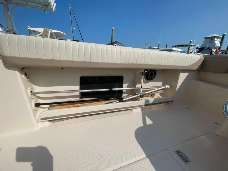 Slide: The Image of 2014 Grady-White Freedom 255 boat interior with rod storage and seating. - 40