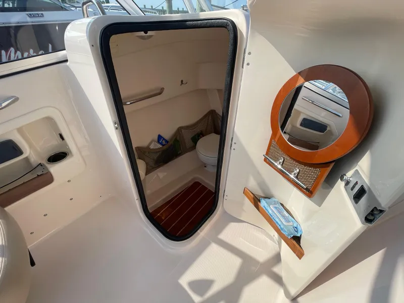 Slide: The Image of 2014 Grady-White Freedom 255 boat interior with compact bathroom and mirror. - 41
