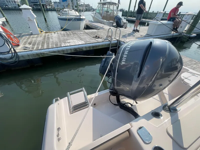 Slide: The Image of 2014 Grady-White Freedom 255 boat docked with Yamaha outboard motor. - 44