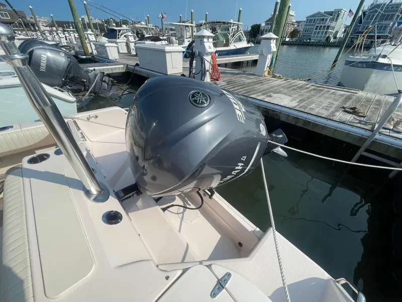 Slide: The Image of 2014 Grady-White Freedom 255 boat with Yamaha outboard motor docked at marina. - 45