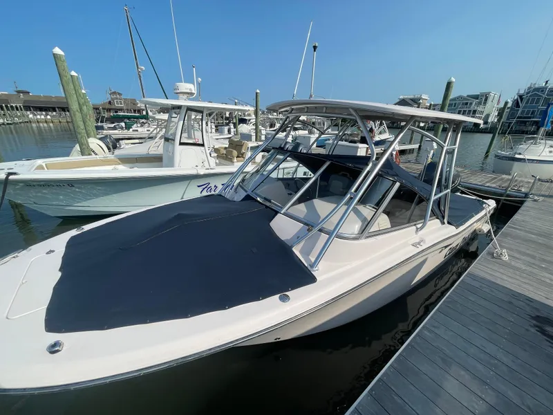 Slide: The Image of 2014 Grady-White Freedom 255 boat docked at marina under clear blue sky. - 47