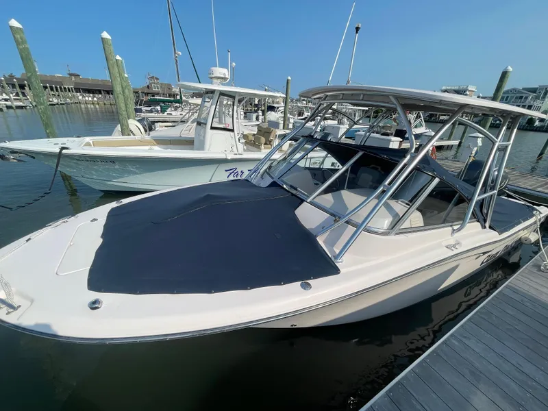 Slide: The Image of 2014 Grady-White Freedom 255 boat docked at marina under clear blue sky. - 48
