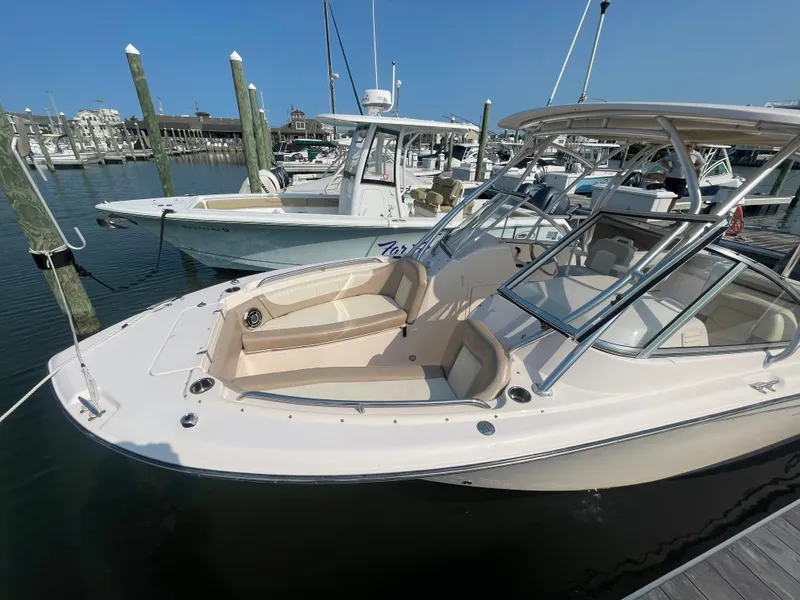 Slide: The Image of 2014 Grady-White Freedom 255 boat docked at marina under clear blue sky. - 7