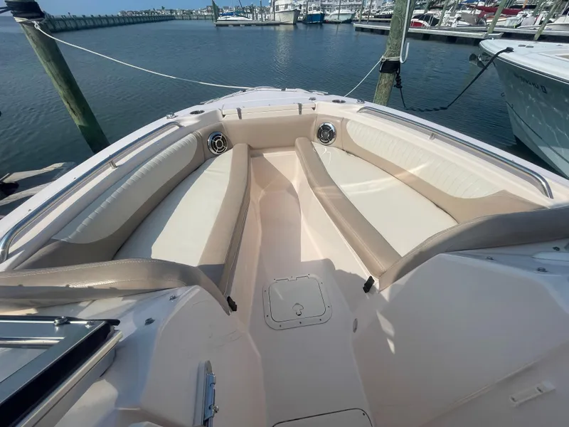 Slide: The Image of 2014 Grady-White Freedom 255 boat interior with spacious seating at marina. - 8