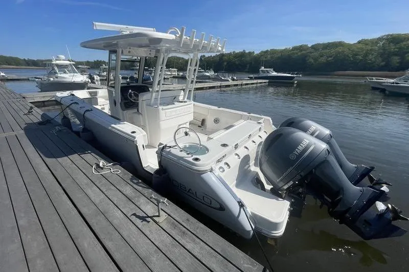 The Image of 2023 Robalo R270 Center Console boat docked with twin Yamaha engines. - 1