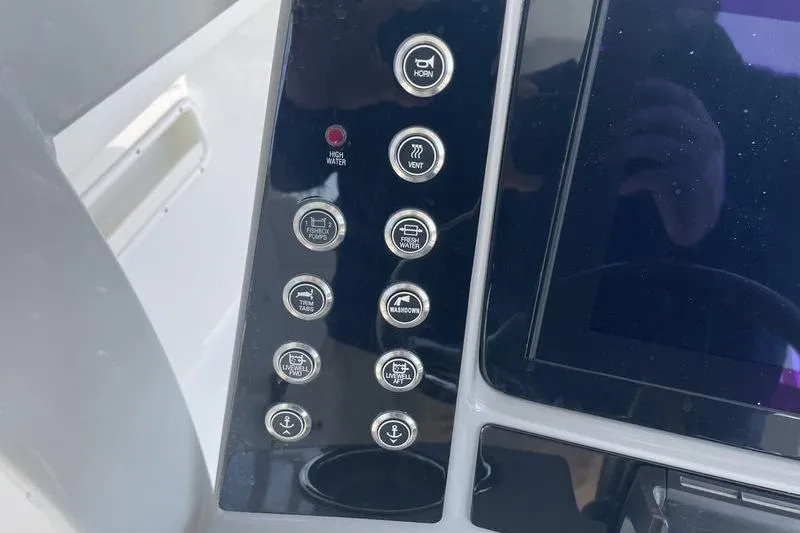 Slide: The Image of 2023 Robalo R270 Center Console dashboard with control buttons and display screen. - 10