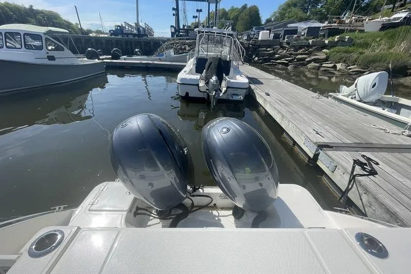 Slide: The Image of 2023 Robalo R270 Center Console docked with dual outboard engines. - 12